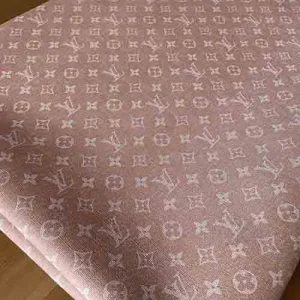 a pink louis vuitton synthetic leather fabric which seems like a denim