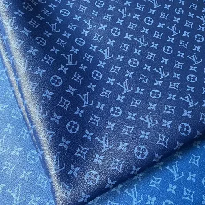 navy louis vuitton artificial fabric by the yard for sale. base color of fabric is navy and lv monogram is pale blue