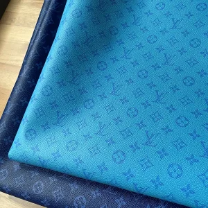 That Louis Vuitton leather fabric has a light blue base colour and blue LV letters on it