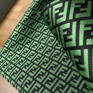 fendi fabric which has black background and green FF pattern on it