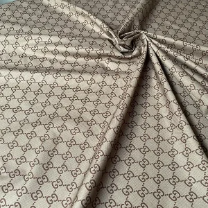 gucci brown cotton thin fabric with black gg patterns on it